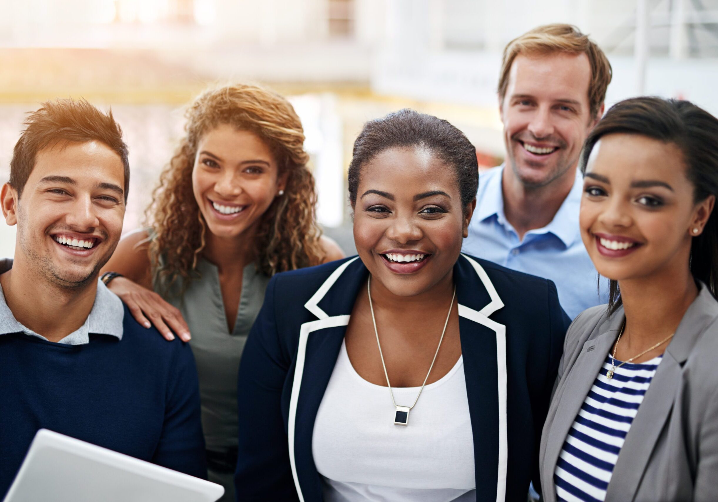 Portrait of a group of smiling coworkers standing in an office